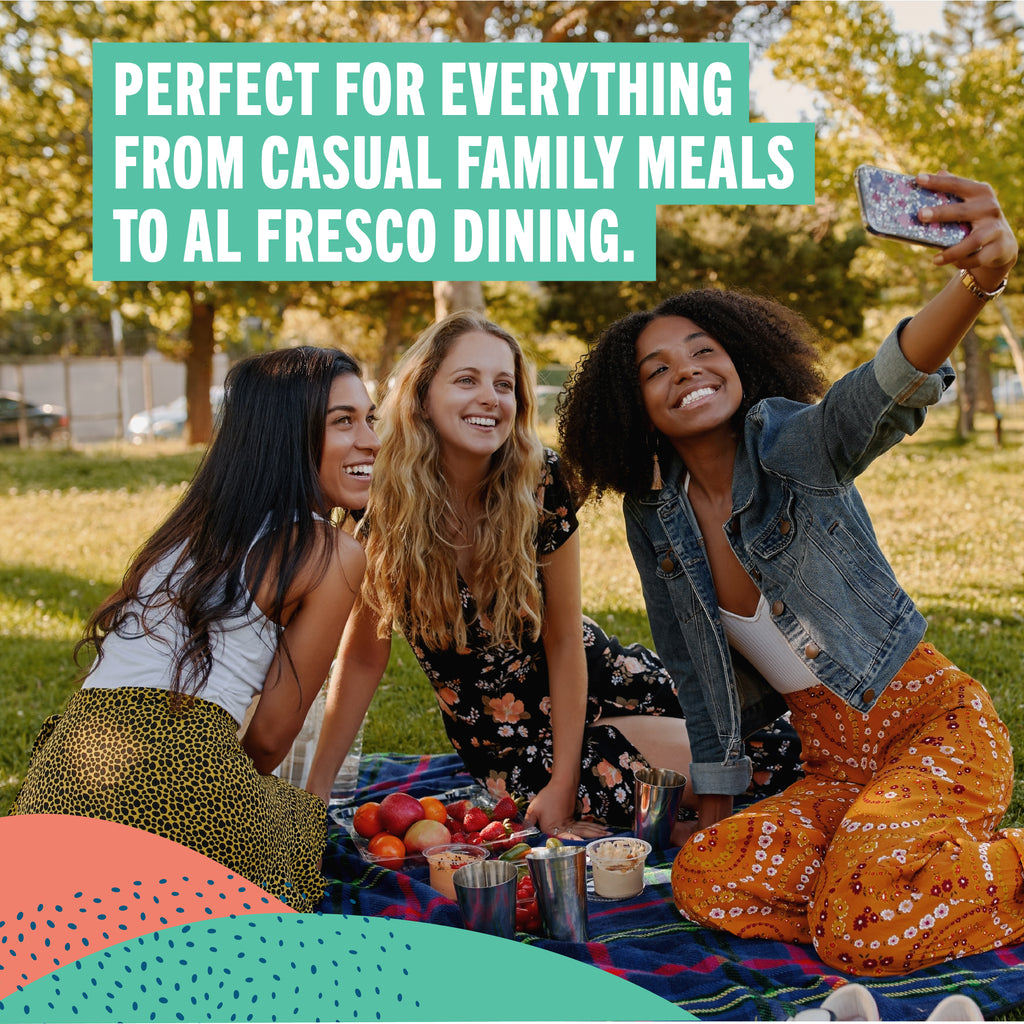 Three women sitting on a blanket outdoors with text overlay about versatile use for meals and dining.