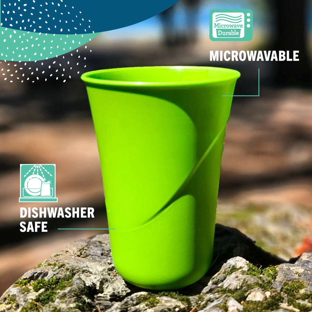 An apple green Preserve Everyday tumbler cup on a earthy rock, with the graphic captions "microwavable" and "dishwasher safe".